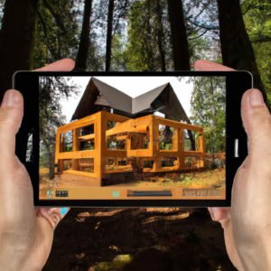 Une personne brandissant un iPad avec une photo d’une maison en construction.